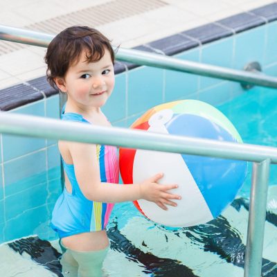 boy with a beach ball on steps